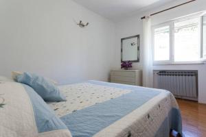 1 dormitorio con 1 cama grande y espejo en Holiday Home Platanus en Trsteno