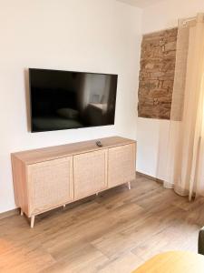 a living room with a flat screen tv on a wall at Eifel Apartment in Antweiler
