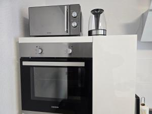 a microwave sitting on top of a black oven at Big Apartment in Krefeld City, Große Ferienwohnung in Krefeld Zentrum in Krefeld +23 photos