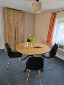 a dining room with a table and chairs with flowers on it at Landhaus Pieper in Hohnstein