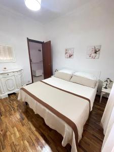 a bedroom with a large white bed in a room at La casa by M&G vacation home in Soglio +23 photos