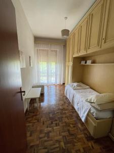 a bedroom with a bed and a table and a window at La casa by M&G vacation home in Soglio