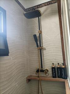a shower with a shower head in a bathroom at Ocean Pirate in Costa de Antigua