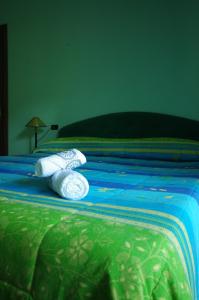 two towels on a bed with a blue comforter at Affittacamere Villa Rosa in Pacentro