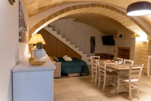 a living room with a staircase and a table and chairs at Casa Dogana in Gallipoli