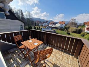 a wooden deck with two chairs and a table at Ferienwohnung Wiese in Langelsheim