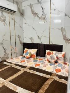 a bed with pillows on it in a room at Arora guest house in Amritsar