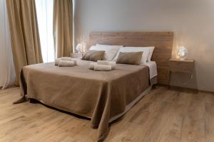 a bedroom with a large bed with two towels on it at Casa Dogana Apartment in Gallipoli