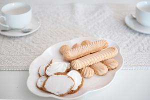 a plate of pastries on a table with a cup of coffee at SUNRISE SARDINIA Olbia in Olbia