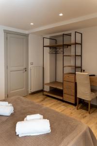 a bedroom with a bed with two towels on it at Casa Dogana Apartment in Gallipoli +4 photos