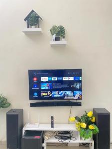 a flat screen tv hanging on a wall at Villa Pondok Ima in Tlekung