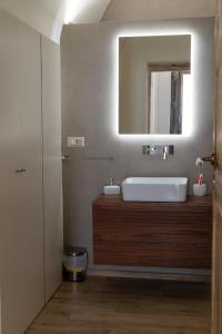 a bathroom with a sink and a mirror at Casa Dogana Apartment in Gallipoli