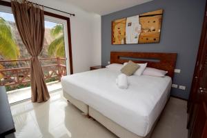 a bedroom with a bed and a large window at Luxury and confort in Quadra Alea in Playa del Carmen +57 photos