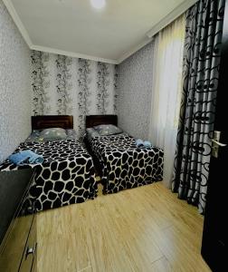 Postel nebo postele na pokoji v ubytování Butichi Guest House