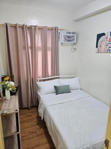 a small bedroom with a bed and a window at Seawind Condominium Staycation by Resty Estor,REB in Davao City