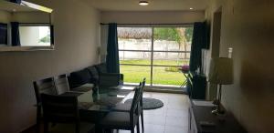 a dining room with a table and chairs and a window at Increible Apartment with beach Monterrey/Apodaca in Monterrey