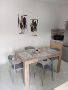 a wooden table and chairs in a kitchen at VillaPouliezos Apartments in Alikanas +30 photos