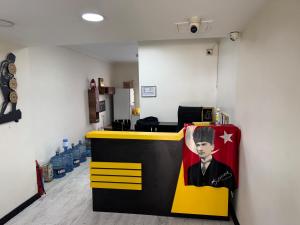 an office with a counter with a picture of a man at Pin Suite in Buyukcekmece