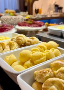 a bunch of trays of food on a table at Hotel Locanda Casa D'Oro in Gramado