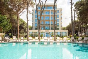 una piscina con sedie e un edificio di Hotel Skanderbeg a Golem