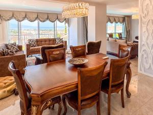 a dining room with a table and chairs and a living room at Villa Limon in Kuşadası +58 photos