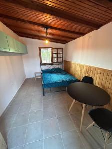 a room with a bed and a table and chairs at Private house near Amarynthos, Evia, Greece in Amarinthos