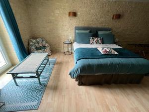 Postel nebo postele na pokoji v ubytování Chambres d’hôtes de l’Ancienne Auberge