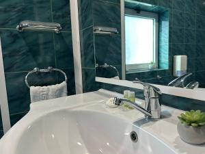 a bathroom with a sink and a mirror at Avenue Palm Eforie in Eforie Nord +97 photos