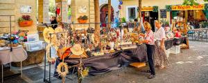 a group of people standing in front of a table filled with items at SERIGNAN Vacances au soleil confort XXL in Sérignan