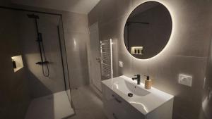 a bathroom with a sink and a mirror and a shower at La LUNA in Le Portel +10 photos