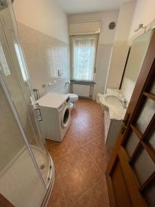 a bathroom with a shower and a toilet and a sink at L'Angolo Verde in Caldonazzo