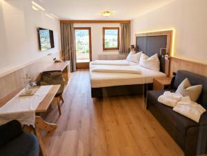 A bed or beds in a room at Hotel Alpenpanorama