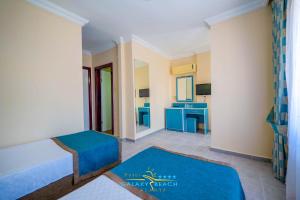 A bed or beds in a room at Galaxy Beach Hotel Alanya