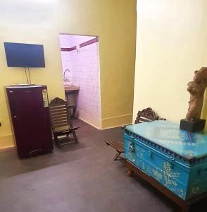 a room with a tub and a table and a desk at Mandira's Home in Kolkata