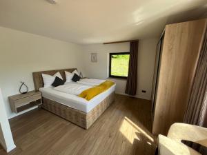 a bedroom with a large bed and a window at Ferienwohnung Natur & Spa in Wiggensbach +14 photos