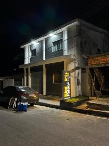 a car parked in front of a house at night at Hotel King Palace - Hotel Irituia in Irituia