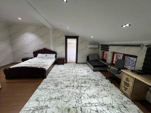 a bedroom with a bed and a large rug at Anor Avenue Hotel in Tashkent