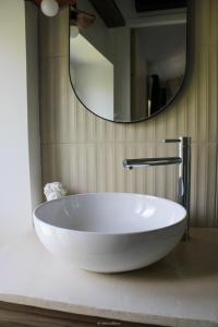 a white sink in a bathroom with a mirror at L escale Antique in Nîmes +13 photos