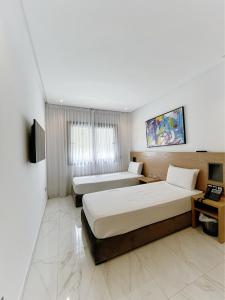 Posteľ alebo postele v izbe v ubytovaní Twin Hotel Tanger