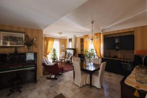 a kitchen and living room with a table and chairs at Panoramic & Exclusive Suite in Enna