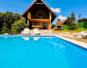 a house with a swimming pool in front of a house at Foresta Home in Gradačac