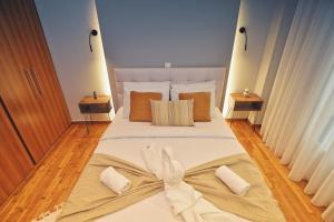 a bedroom with a large bed with a bow on it at Seren Studio near Victoria Metro-Earthy Tones & Comfort in Mesochórion
