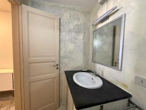 a bathroom with a sink and a mirror at Casa Cappero - sul porto di Malfa in Malfa