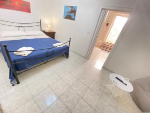 a bedroom with a bed and a table and a couch at Bentivegna Apartments in Syracuse +6 photos