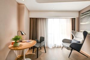 a room with a table and chairs and a window at Atour Hotel Beijing Lishuiqiao in Changping