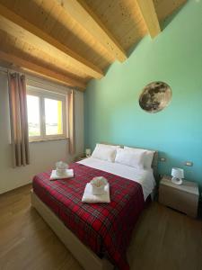 a bedroom with a bed with two towels on it at I Colori dell'Infinito in Recanati +67 photos