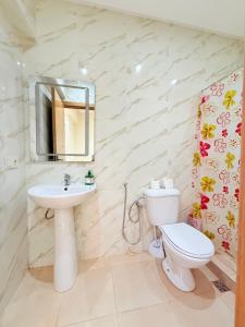 a white bathroom with a sink and a toilet at Appart N35 COSY CONFORT FAMILY in Marrakech +8 photos