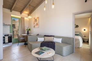 a living room with a couch and a table at Gardenia apartments in Svoronata
