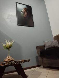 a living room with a picture of a lion on the wall at Apartamento Centro Cruz Alta in Cruz Alta