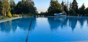a large swimming pool with a slide in a park at Ferienhaus St. Johannis in Werben